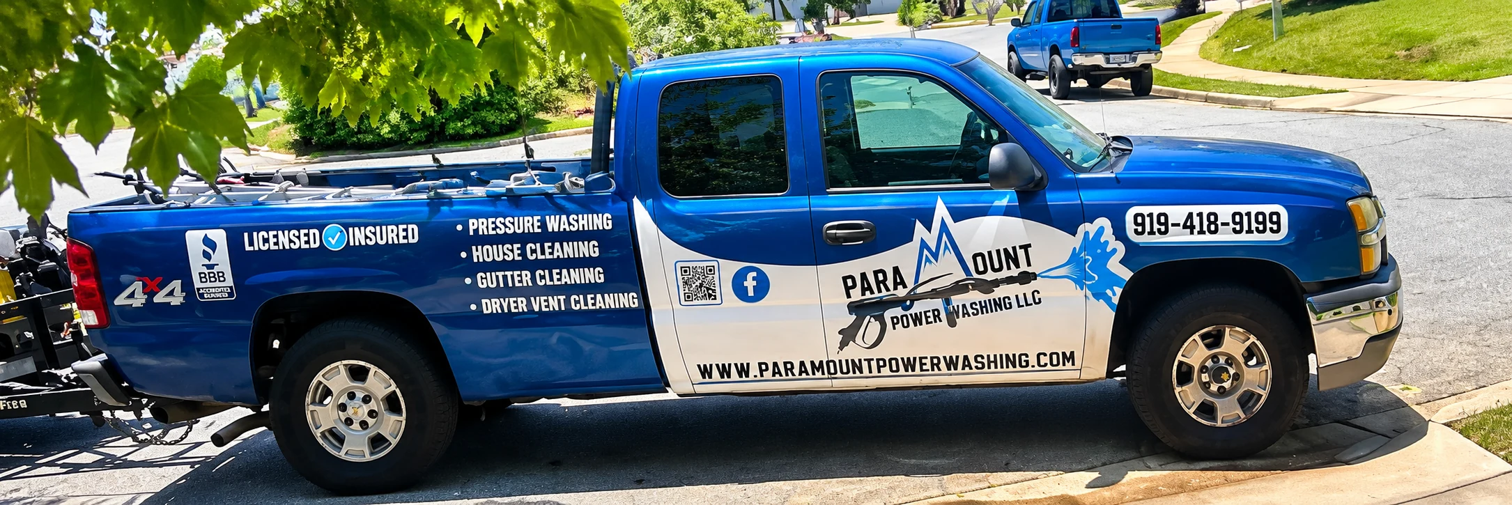 Paramount Power Washing truck, licensed and insured, with the company phone number